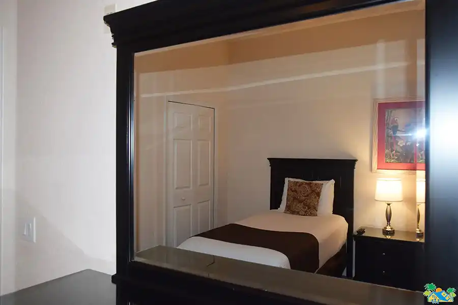 View of the twin guest bedroom reflected in dressing mirror